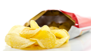 Potato chips spilling from a traditional plastic-and-foil bag.