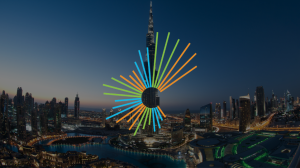 An aerial view of Dubai's coastline at sunset. The Circular Economy Month starburst motif is overlaid.